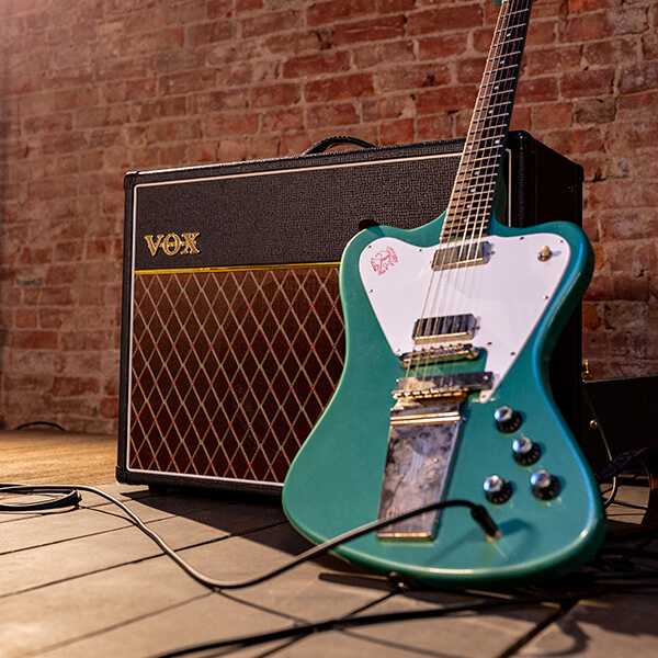 guitar laying on vox amp