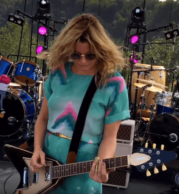 musician, Grace Potter, playing electric guitar in concert