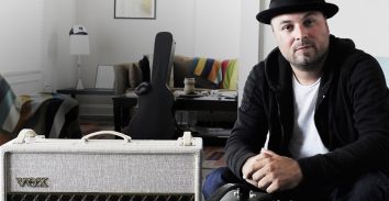 artist, Guthrie Trapp, sitting in appartment beside VOX amplifier