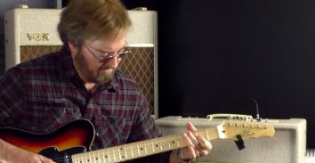 artist, Jerry Donahue, playing electric guitar in front of VOX amplifier