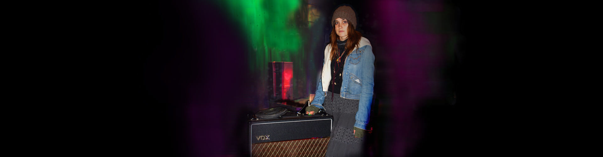 artist,, Theresa Wayman, standing next to VOX amplifier
