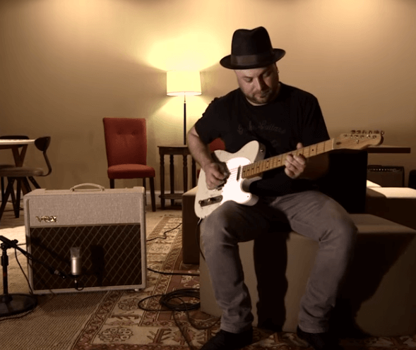 artist, Guthrie Trapp playing electric guitar  in appartment bside VOX amplifier