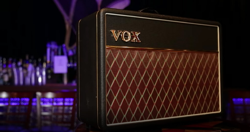 brown and black VOX amplifier with bar in background
