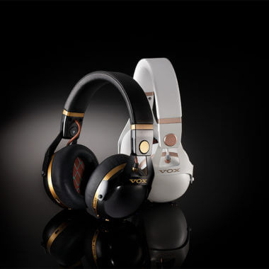 two pairs of VOX VHQ1 headphones in white with gold details and black with gold details