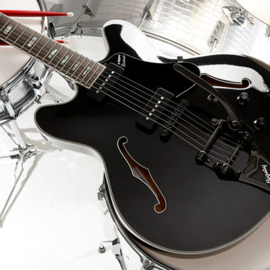 body of black electric guitar