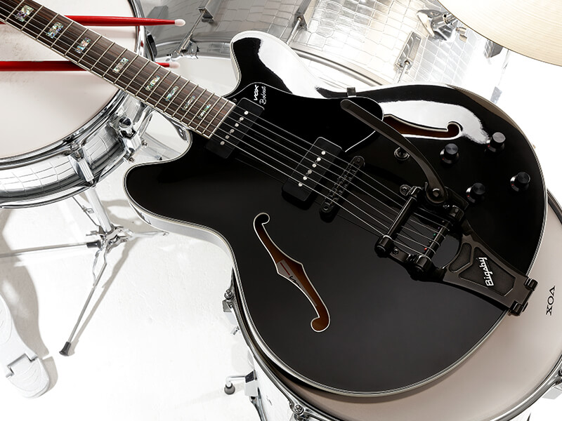 body of black electric guitar