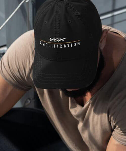man wearing Vox Amplification hat looking down
