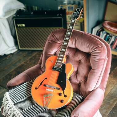 Vox Giulietta Vga-5td Archtop Electric Guitar Pearl Orange on couch.