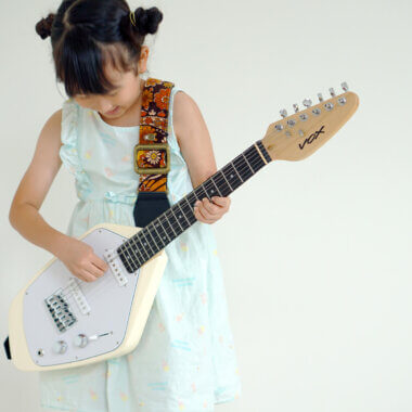 Vox Mark V Mini Guitar white being played by a kid.