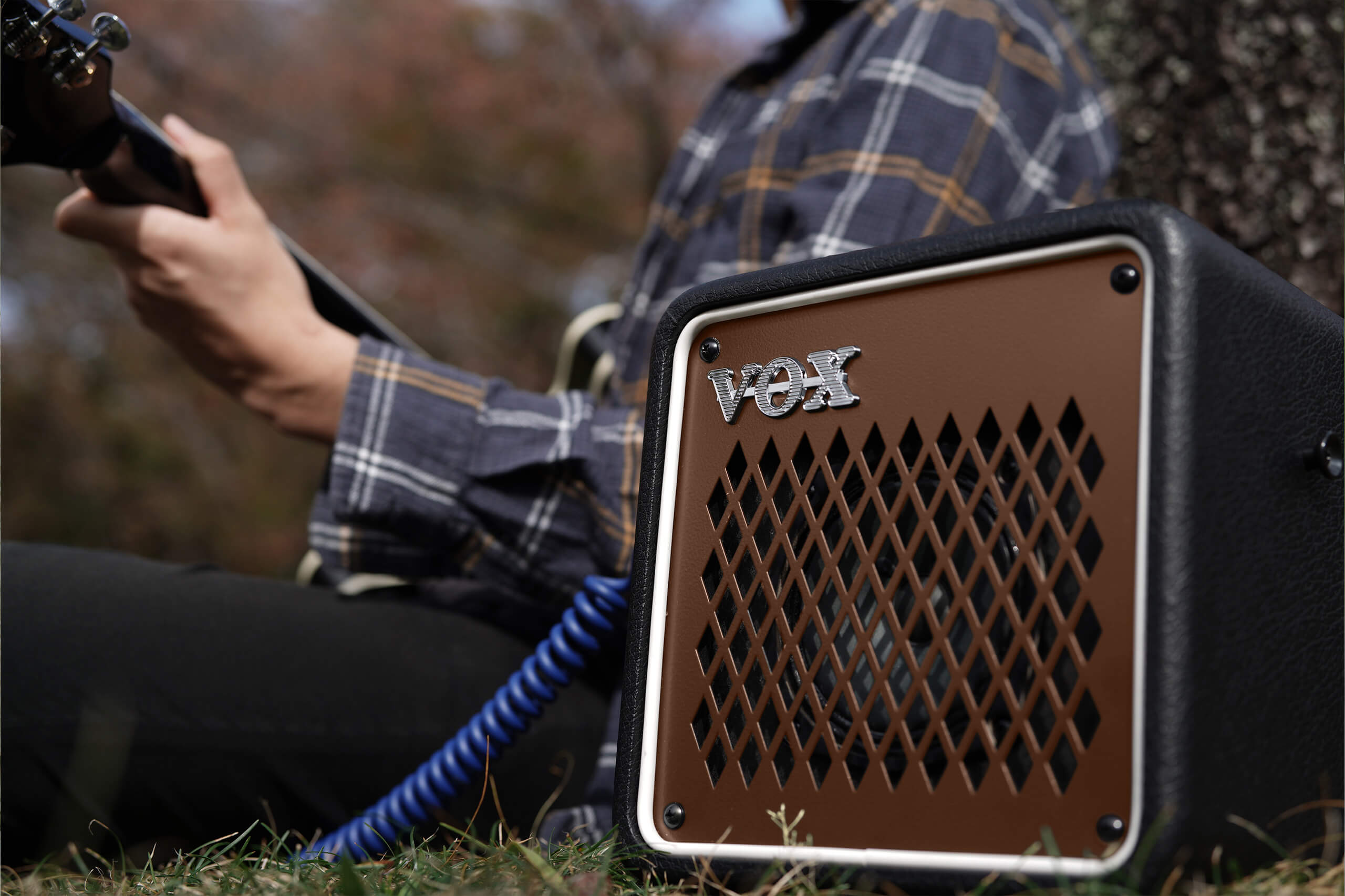 Vox mini go 10 earth brown on the ground with artist playing.